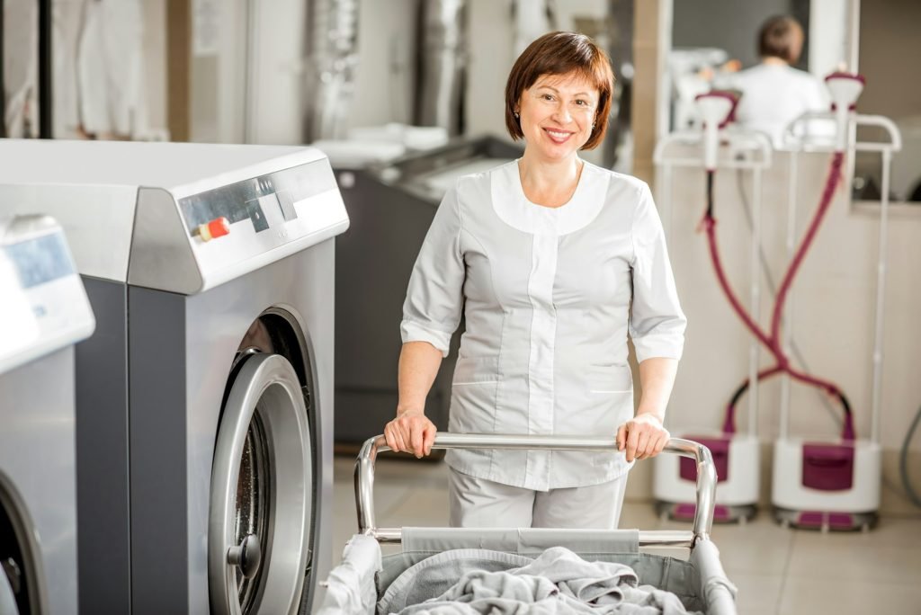 Senior washwoman in the laundry